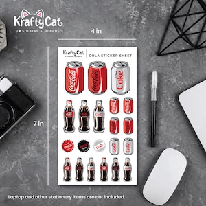 Op de afbeelding: Een stickervel van 10,16 cm bij 17,78 cm met de titel COLA STICKER SHEET van KraftyCat, met diverse illustraties in Coca-Cola-thema, waaronder frisdrankblikjes, glazen flessen en kroonkurken in de kleuren rood, zwart, wit en zilver.