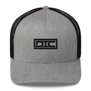 May include: A gray and black trucker hat with a black embroidered logo that says "DIC" in a rectangular box.