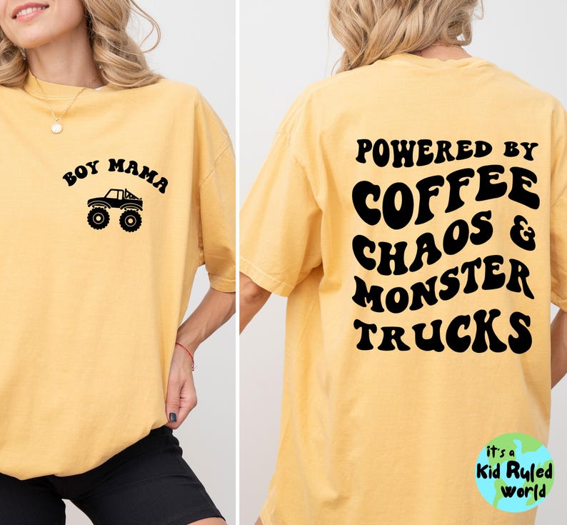 May include: Mustard yellow t-shirt with black text and graphics. The front reads "Boy Mama" above a monster truck graphic. The back says "Powered by Coffee Chaos & Monster Trucks". The shirt is a casual, oversized fit.