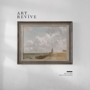 May include: Framed landscape painting featuring a coastal scene with a sandy beach, ocean, and cloudy sky. The artwork has a muted color palette with a dark gray frame. The text "ART_REVIVE" is at the top left.