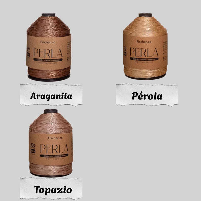 May include: Three spools of Fischer.co Perla polyester cord in shades of dark brown, light beige, and muted mauve. Each spool features a brown paper label with the text Perla, Cord&atilde;o de Poli&eacute;ster Brilho, and Bright Polyester Cord printed on it.