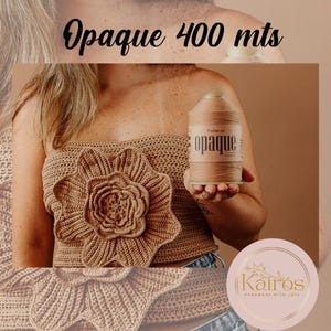 May include: A close-up of a crocheted top with a large flower design. The top is made with brown yarn. A spool of brown yarn labelled "opaque 400 mts" is in the image.