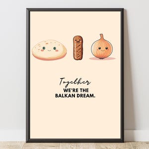 May include: A framed print featuring cartoon illustrations of a pita, sausage, and onion with smiling faces. The text "Together we're the Balkan Dream" is written below the illustrations in black script.