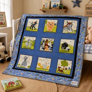 May include: A blue patchwork quilt featuring nine square panels with illustrations of farm animals including a cow, pig, horse, goat, sheep, cat, chicken, and dog, surrounded by a blue border with a small repeating farm animal pattern.
