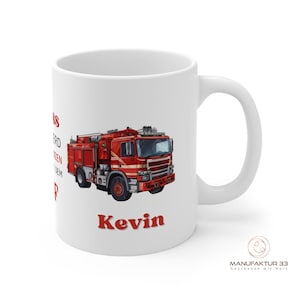 May include: White ceramic mug featuring a red fire truck illustration and the name "Kevin" in red. The mug also has text in red on the left side. A logo is visible on the bottom right.
