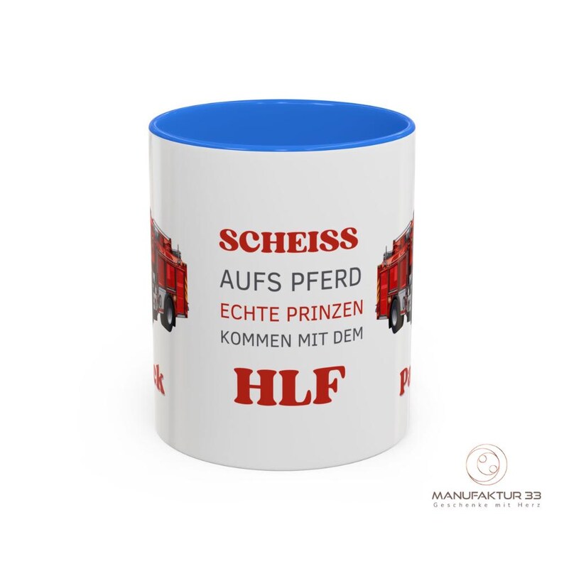 May include: White ceramic mug with a blue interior and a red fire truck graphic. The mug features German text in red, including the word "HLF". The mug has a glossy finish and a handle.
