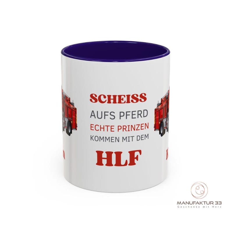 May include: White ceramic mug with a navy blue interior and a red and white design. The mug features a red fire truck graphic and German text. The text includes the word "HLF" in red. The mug has a glossy finish.