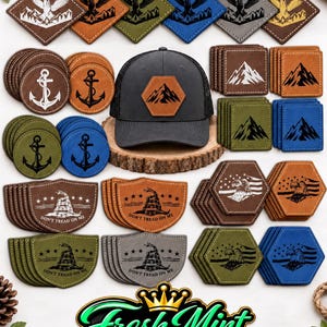 May include: A dark grey baseball cap with a hexagonal mountain patch, surrounded by various leather-like patches and coasters featuring anchor, mountain, eagle, and Gadsden flag designs with the text "DON'T TREAD ON ME" and a "Fresh Mint CUSTOMS" logo.