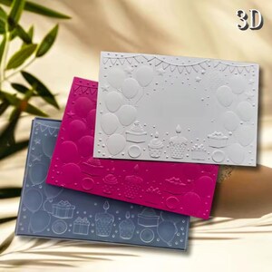 May include: Three 3D embossed birthday cards in grey, fuchsia, and white. The cards feature raised designs of balloons, cupcakes, gifts, and a banner. The word "3D" is in the upper right corner.
