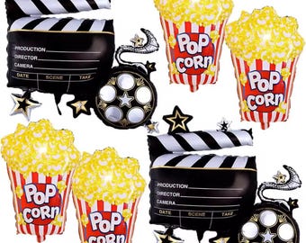 Puede incluir: Un conjunto de globos de aluminio con temática de cine. El conjunto incluye claquetas en blanco y negro, rollos de película, cubos de palomitas de maíz con el texto "Pop Corn" y adornos en forma de estrella. Los cubos de palomitas tienen rayas rojas y blancas.