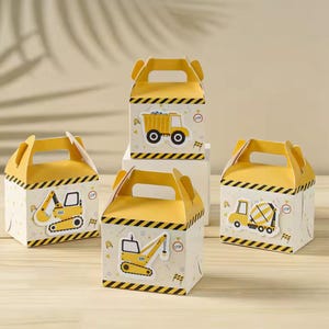 May include: Four construction-themed gift boxes in yellow and white, each with a different vehicle graphic: a dump truck, excavator, cement mixer, and crane. The boxes have yellow tops with black and yellow hazard stripes. The boxes have handles.