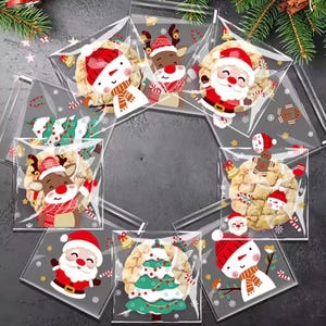 May include: A collection of clear plastic treat bags featuring festive Christmas graphics including Santa Claus, reindeer, snowmen, and decorated pine trees. Each bag contains a round cookie and is printed with small snowflakes and candy canes.