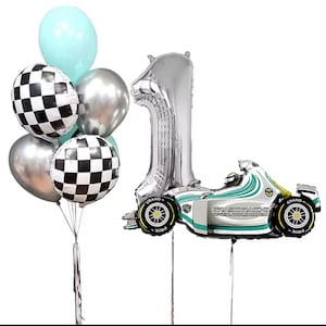 May include: A collection of birthday balloons. Includes a silver number one balloon, a race car balloon, and a bouquet of balloons in silver, light blue, and checkered patterns. The race car balloon has the text "GRASORACING".