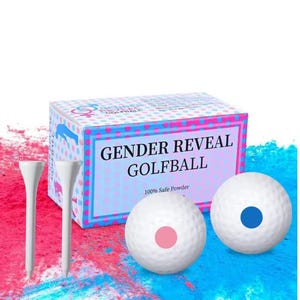 May include: A box of gender reveal golf balls with the text "GENDER REVEAL GOLF BALL" and "100% Safe Powder". Two white golf tees and two golf balls are visible, one with a pink dot and one with a blue dot.