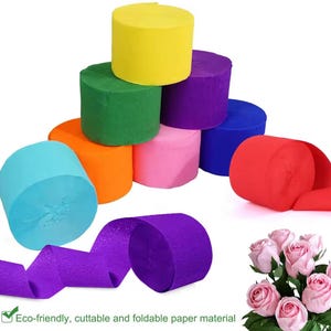 May include: A collection of colorful crepe paper rolls in shades of yellow, green, orange, pink, purple, blue, and red. A purple roll is unrolled, and the text "Eco-friendly, cuttable and foldable paper material" is visible.