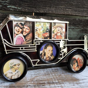 May include: A vintage car-shaped photo frame with five openings for pictures. The frame is made of dark brown plastic with silver accents. The frame is decorated with a silver grill and headlights. The frame is perfect for displaying family photos.