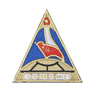 May include: Embroidered patch in a triangular shape with a blue background and gold trim. The design includes a red flag with a star and hammer and sickle, a bridge, and the text "CO106-1".