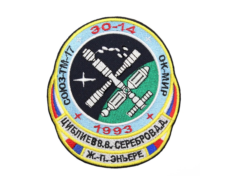 May include: A circular embroidered patch with a blue, white, and red border. The center of the patch is black with a white and gray space station design. The text "30-14", "СОЮЗ-ТМ-17", "ОК-МИР", "1993", "ЦИБЛИЕВ В.В. СЕРЕБРОДА", and "Ж.-П. ЭНЬЕРЕ" is embroidered in yellow, white, and red.