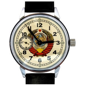 Soviet Molnija Watch. The white dial beautifully displays the USSR Coat of Arms with a five-pointed red star on top