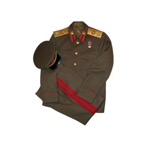 May include: An olive green military uniform jacket featuring gold-toned buttons, red collar tabs, and gold shoulder boards with star insignias. A matching olive green peaked cap with a red band and black visor is positioned next to the jacket.