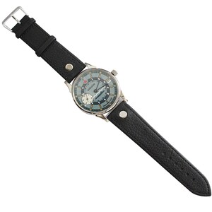 A black leather strap is included