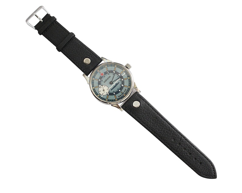 A black leather strap is included