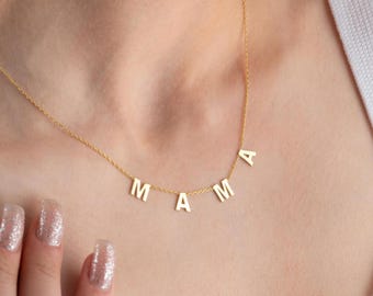 May include: A gold necklace with the word "MAMA" spelled out in individual letters.