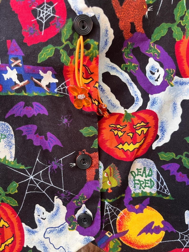 Vintage 90s Basic Editions Halloween Vest - Spooky Grannycore Print M/L A 90s vintage Basic Editions Halloween vest, featuring a playful all-over print with ghosts, pumpkins, skeletons, witches, and gravestones on a black background