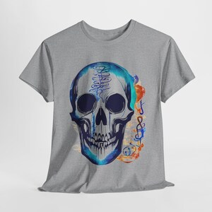 May include: Gray t-shirt featuring a blue and white skull design with musical notes and symbols. The skull has a watercolor effect, with blue and teal hues. The design includes musical notes in orange and blue.