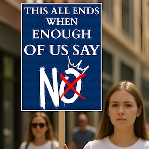 May include: A woman holds a sign with the text "THIS ALL ENDS WHEN ENOUGH OF US SAY NO." The sign is white with blue text and a red "X" through the word "NO." The background shows a blurred street scene.