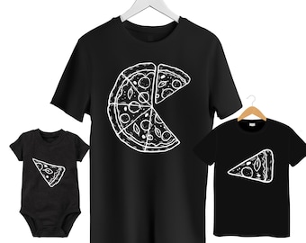May include: Black t-shirts and a baby onesie, each with a white pizza slice design. The adult t-shirt has a large pizza graphic, while the child's shirt and onesie feature a single slice. A fun family matching set.