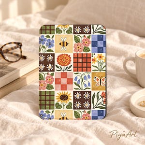 May include: A rectangular tablet case featuring a grid pattern of colorful illustrations including sunflowers, daisies, bees, butterflies, pink and blue flowers, and checkered squares in shades of green, orange, blue, and yellow with PiyaArt text.