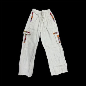 May include: Off-white cargo pants with a drawstring waist. The pants feature two cargo pockets and decorative colorful striped accents on the pockets and sides. The pants are made of a lightweight fabric.