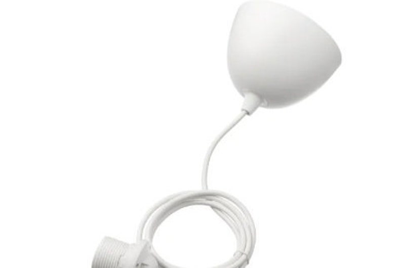 May include: White pendant light with a simple, rounded shade and a white cord.