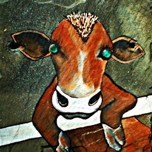 May include: A hand-painted cow with brown and white fur, green eyes, and a spiky brown mohawk. The cow is painted on a textured, green background.