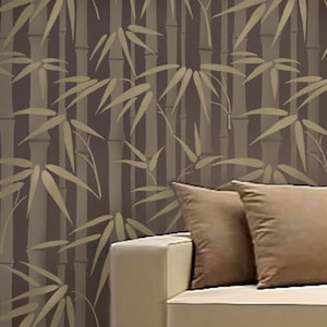 May include: A white couch with two brown throw pillows in front of a wall with a brown and gold bamboo pattern.