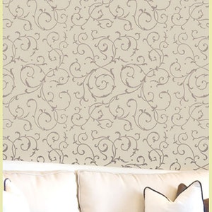May include: A beige wallpaper with a repeating pattern of gray, swirling vines. The wallpaper is shown in a room with a white couch and pillows.