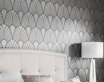 May include: A white headboard with a tufted design against a gray and white geometric patterned wallpaper. A white lamp with a white lampshade sits on a nightstand next to the bed.