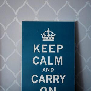 May include: A teal blue sign with a white crown and the text "Keep Calm and Carry On".