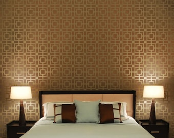 May include: A bedroom with a brown patterned wallpaper, a bed with a white duvet and brown and blue pillows, and two bedside tables with lamps.