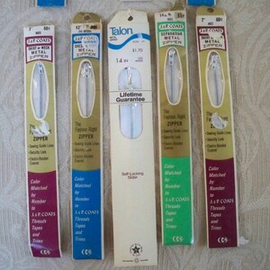 May include: Four packages of J. & P. Coats metal zippers in various colors and lengths. The packages feature the brand name, zipper type, and size. One package is for a 14-inch separating zipper and features the Talon brand name with a lifetime guarantee.