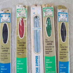 May include: Four packages of J & P Coats zippers in different colors and sizes. The packages are labeled with the brand name, zipper size, and color. The zippers are all metal and have a sewing guide line, security lock, and electro-bonded enamel.