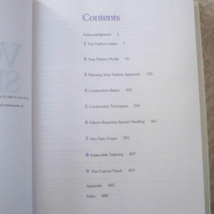 May include: Open book page with the heading "Contents" in purple. The table of contents lists chapters such as "The Fashion Game," "Construction Basics," and "Impeccable Tailoring." The page numbers are visible.