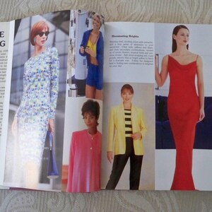 May include: A fashion magazine spread featuring various women's outfits. The outfits include a floral print dress, a blue jacket and shorts set, a pink suit, a yellow blazer with black and white striped top and black pants, and a red dress.
