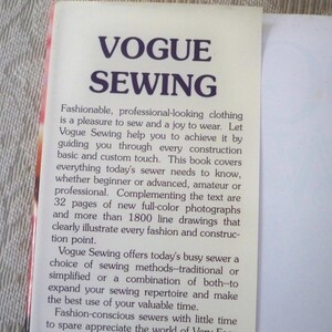 May include: A close-up of a book cover with the title "VOGUE SEWING" in large, dark purple letters. The cover features text describing the book's content, including sewing methods, photographs, and line drawings for sewers of all levels.