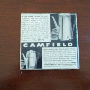 May include: A black and white advertisement for the Camfield "Princess" coffee maker. The ad features a close-up of the coffee maker with a silver finish and a black handle. The text reads "A real coffee "break" for small families, the new Camfield "Princess" makes as few as two (and up to six) cups of the finest coffee you ever tasted-automatically! Strength Selector lets you choose the strength of coffee you prefer; Ready Light signals when the coffee is brewed; and Keep-Hot action keeps your coffee hot for hours! The "Princess" is made of stainless steel, with a safety hinged cover. Only $24.95. CAMFIELD"