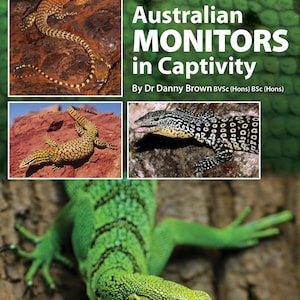 May include: A book cover titled "A Guide to... Australian Monitors in Captivity" by Dr Danny Brown BVSc (Hons) BSc (Hons). The cover features three different types of lizards, including a green lizard, a brown lizard with yellow spots, and a black and white lizard.