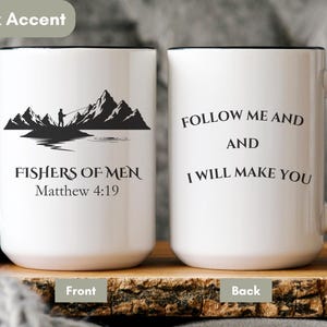 May include: White ceramic mug with a black handle and rim. The front features a silhouette of a fisherman and mountains with the text "FISHERS OF MEN Matthew 4:19". The back of the mug has the text "FOLLOW ME AND AND I WILL MAKE YOU".