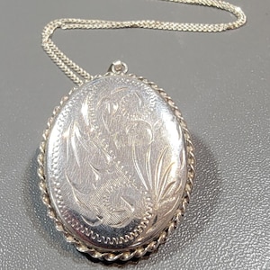 sterling silver locket engraved oval with twisted wire frame room for memento