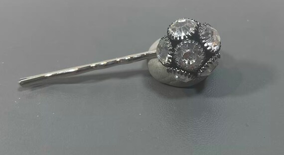Rhinestone hairpin on black bezel set.
